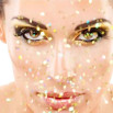 A woman with gold glitter around her face.
