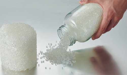 A white granular substance being poured easily while flowing well