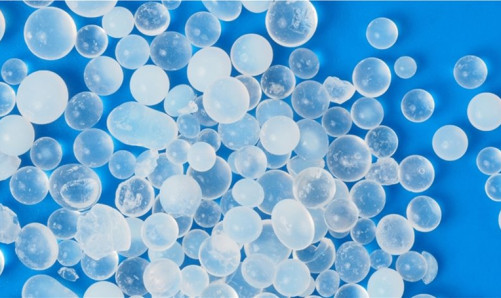 Translucent desiccant beads on a blue background