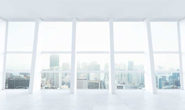 A white building with windows looking out to a city